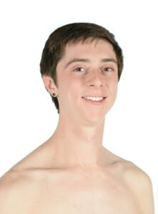 Cody Krause headshot with bare shoulders. Cody has fair skin and short brown hair. He is smiling and looking at the camera.