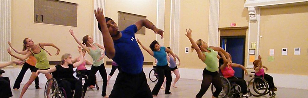Dancers with and without disabilities taking class together