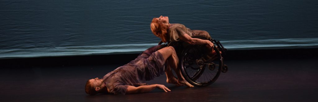 Performance photo of Dancing Wheels Founder Mary Verdi-Fletcher in her wheelchair dancing with partner Matt