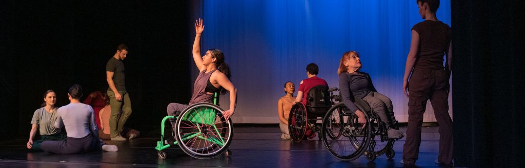 Dancers with and without disabilities performing together on a stage