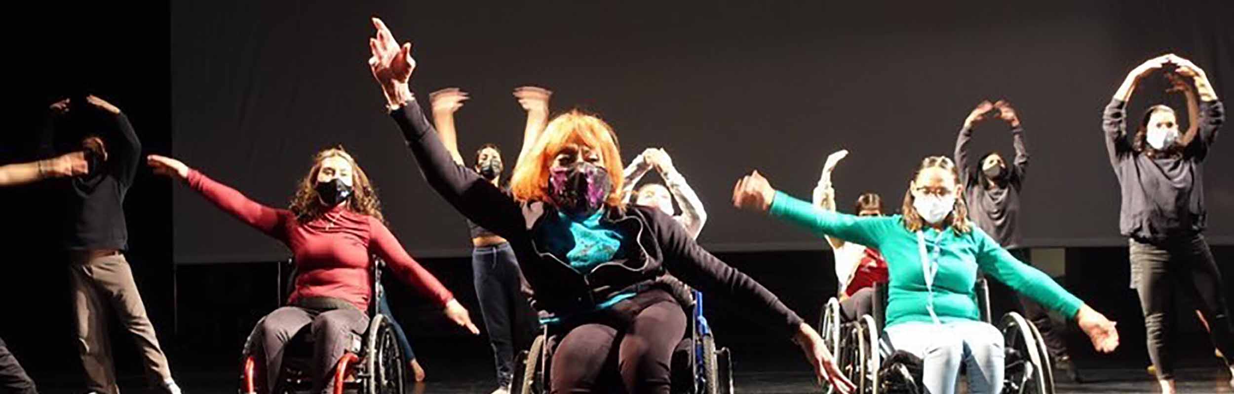 Dancers with and without disabilities taking class together utilizing movement translations