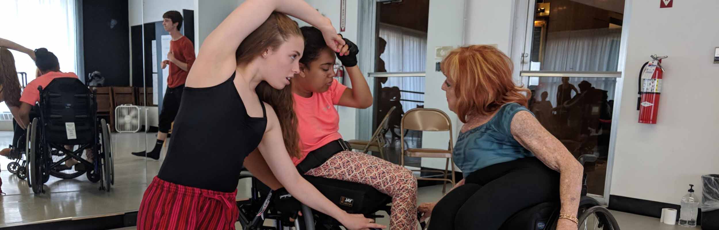 Mary, a sit-down dancer, teaches two students non-traditional partnering