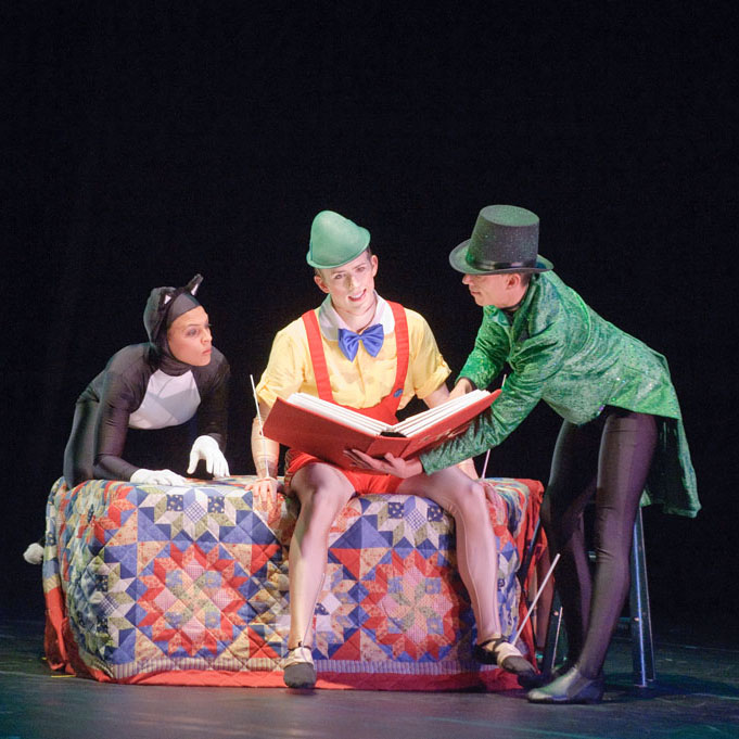Jiminy Cricket character reads to Pinocchio, a wooden boy, and Figaro the cat characters on stage in full-length story ballet Pinocchio!
